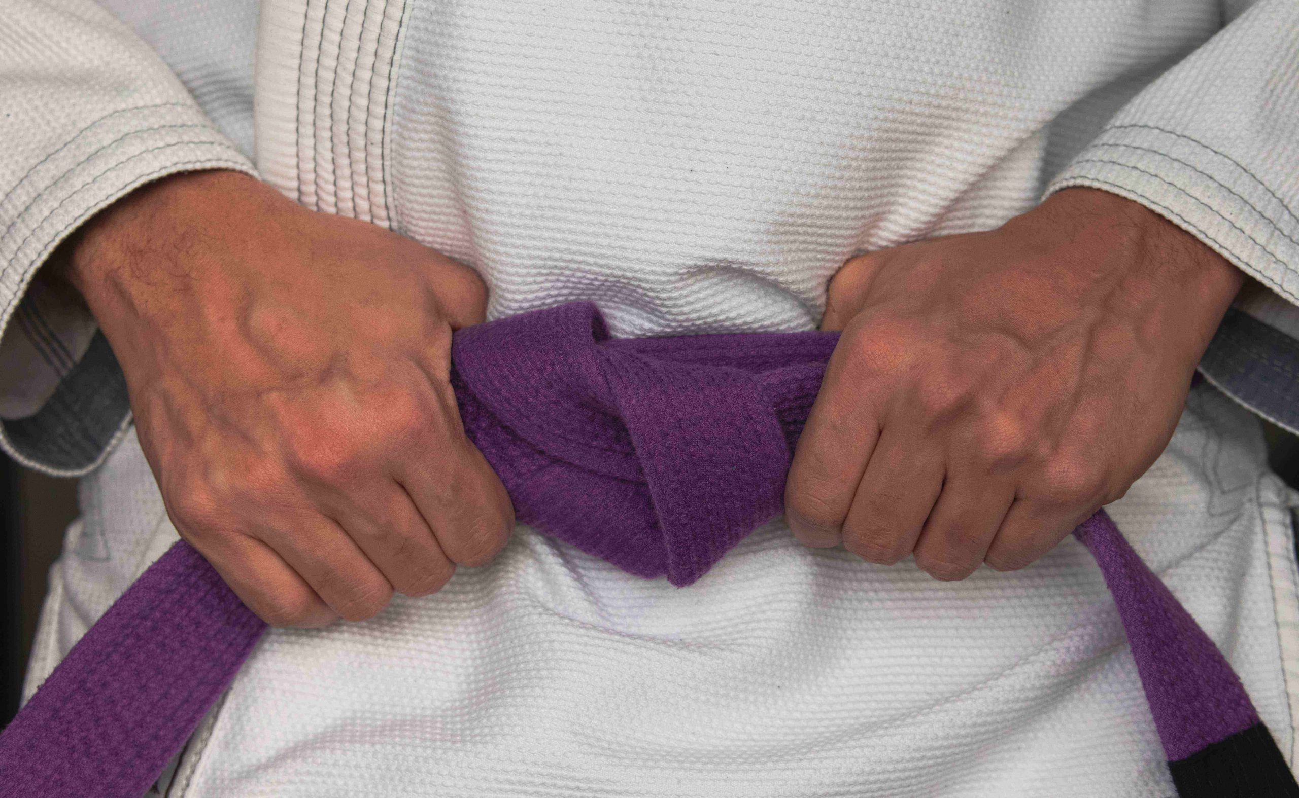 A Brazilian Jiu Jitsu purple belt close up
