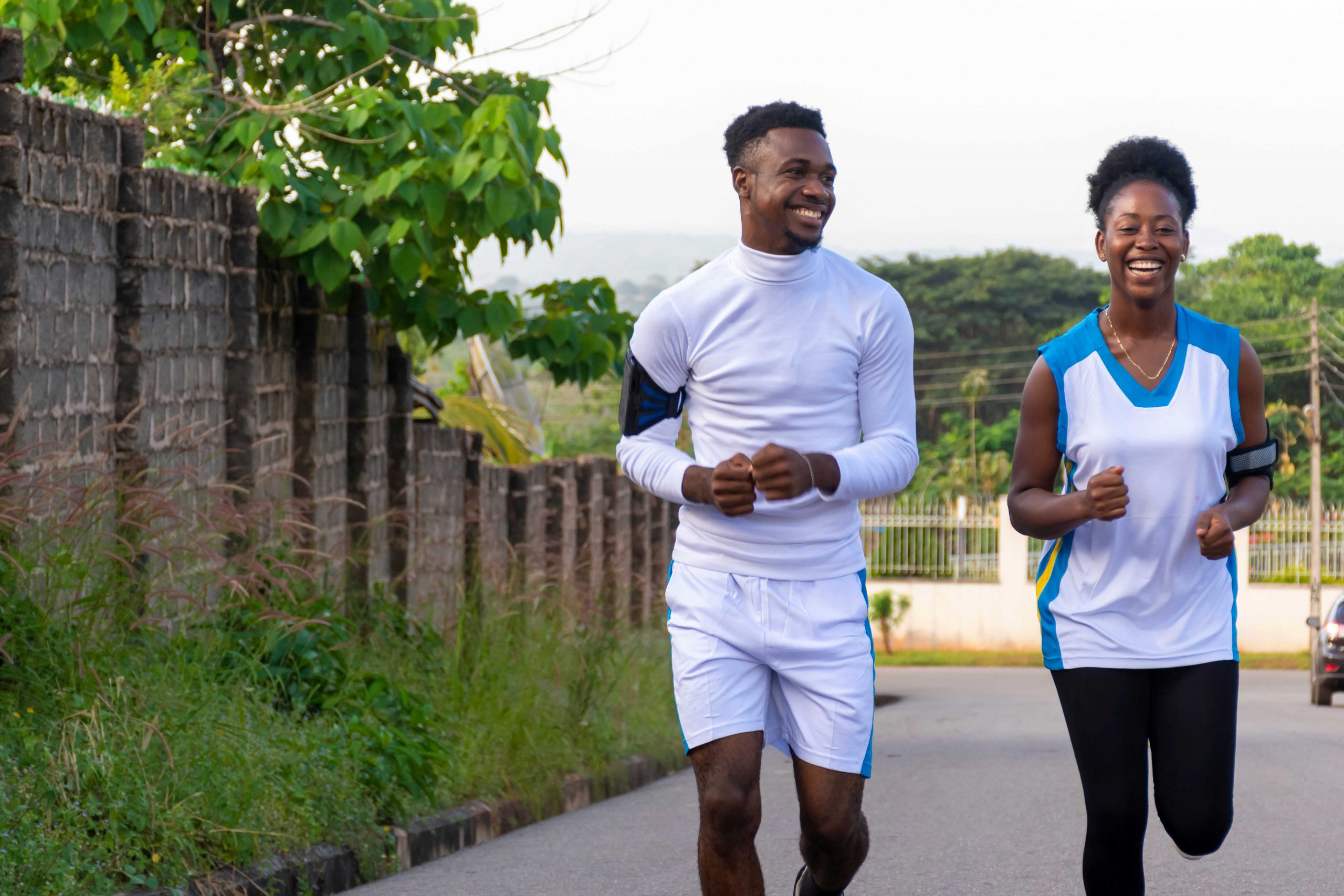 Couple goes for a run, laughing and smiling