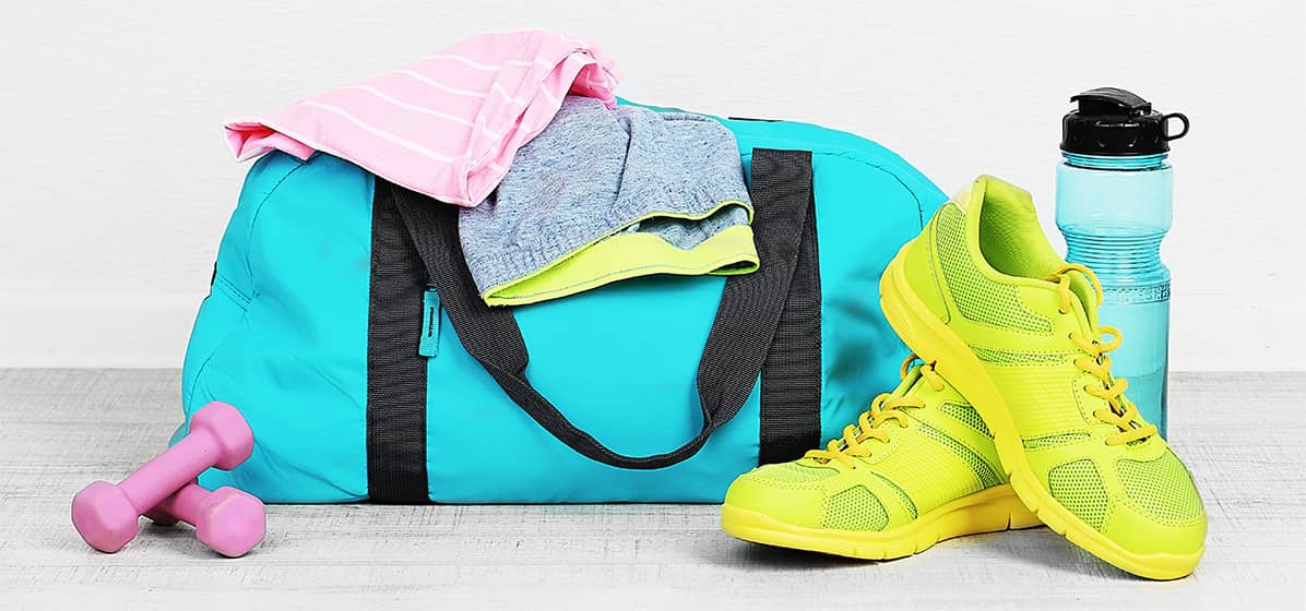 Gym duffle bag with sneakers, water bottle and sweats.